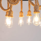 Four filament lamps burning at the foot of their rope swags