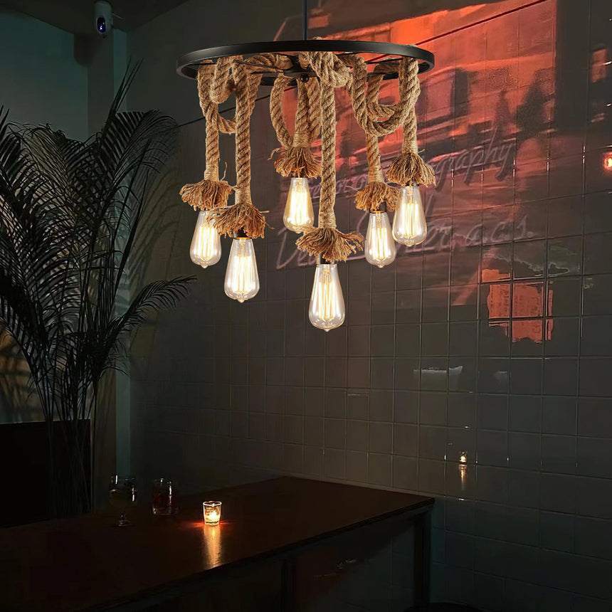 The swags lit in a dark room above a table with a candle on it
