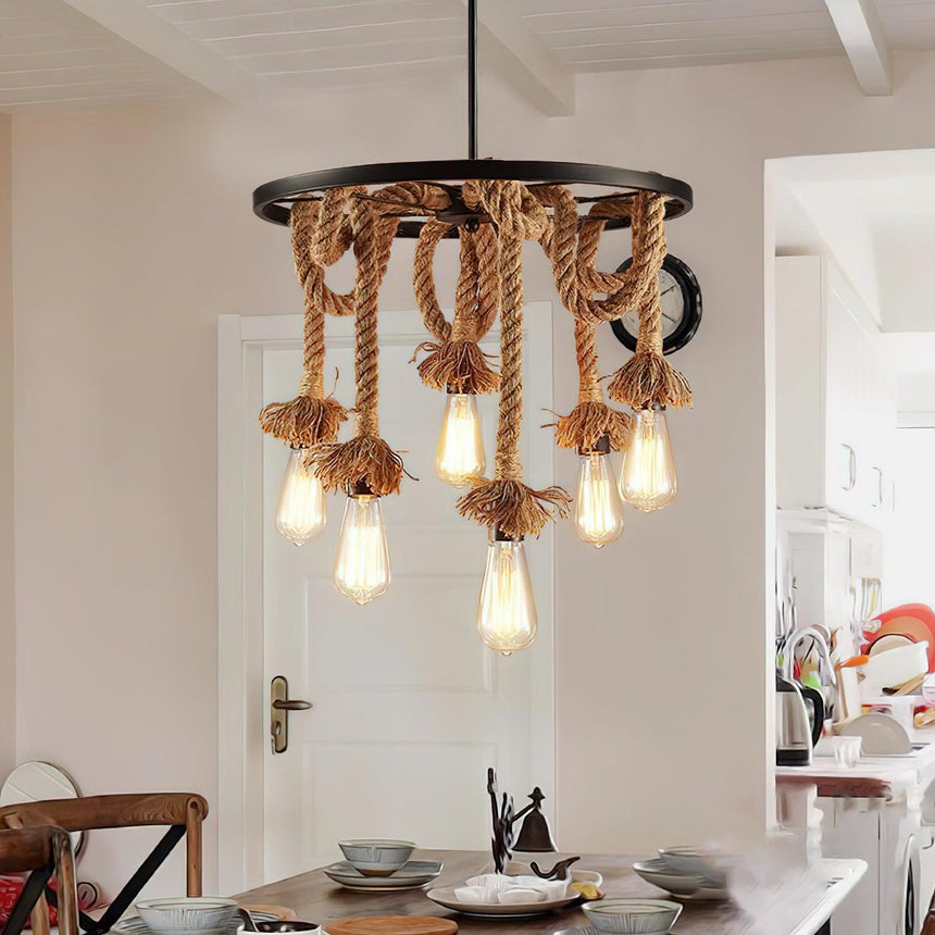 Chandelier lit above a dining table with plates and wishbone chairs