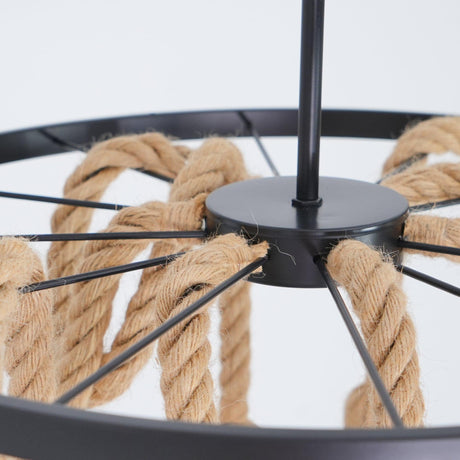 The spoked black iron ring seen from below with rope threaded over it
