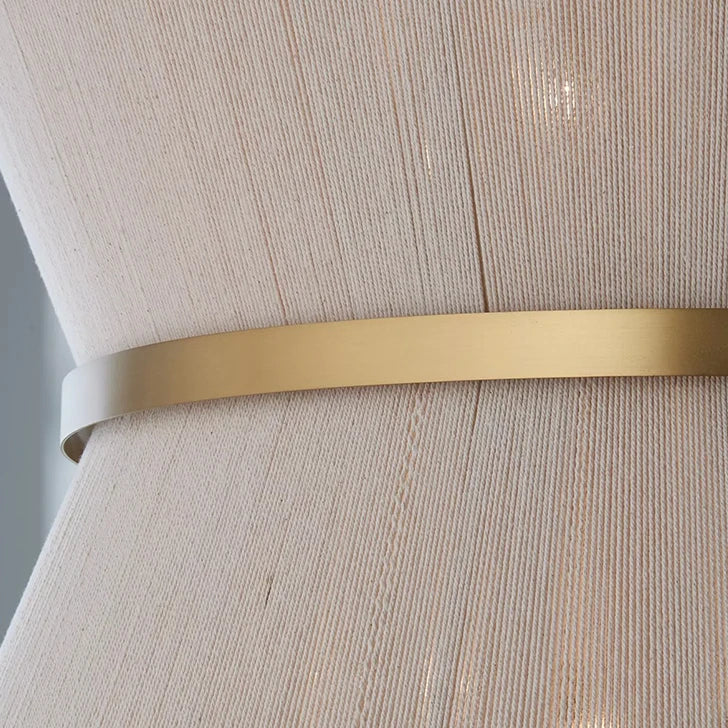 Close view of the brass band across the woven hemp rope