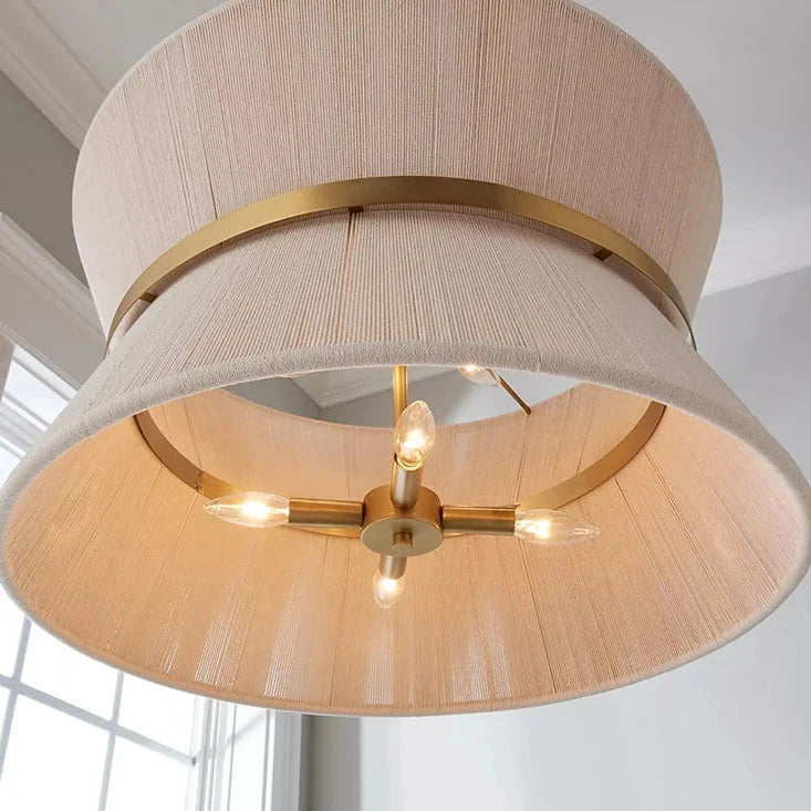 Woven hourglass shade seen from below with its bulbs lit