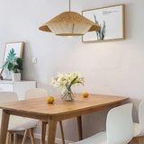 Hemp rope shade above a wooden table with a vase