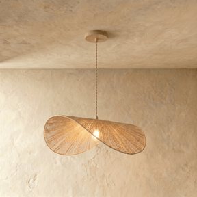 Two overlapping discs of woven pale hemp rope hung from a fine braided cord