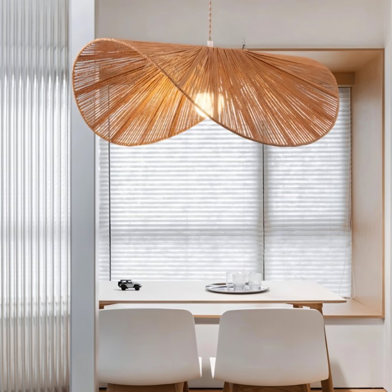 The shade lit over a small table and two chairs in front of a shuttered window