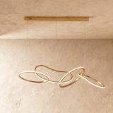 The gold loops spread wider along the bar, each ring lit on its inner face
