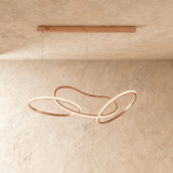 The same interlaced loops in rose gold, lit along the inside of each ring