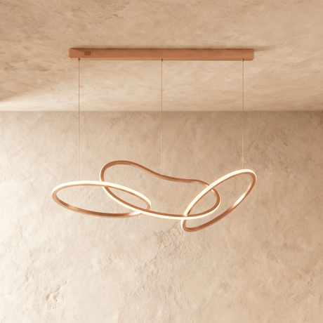 The same interlaced loops in rose gold, lit along the inside of each ring