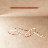 The rose gold loops spread along the bar, rings crossing at several depths