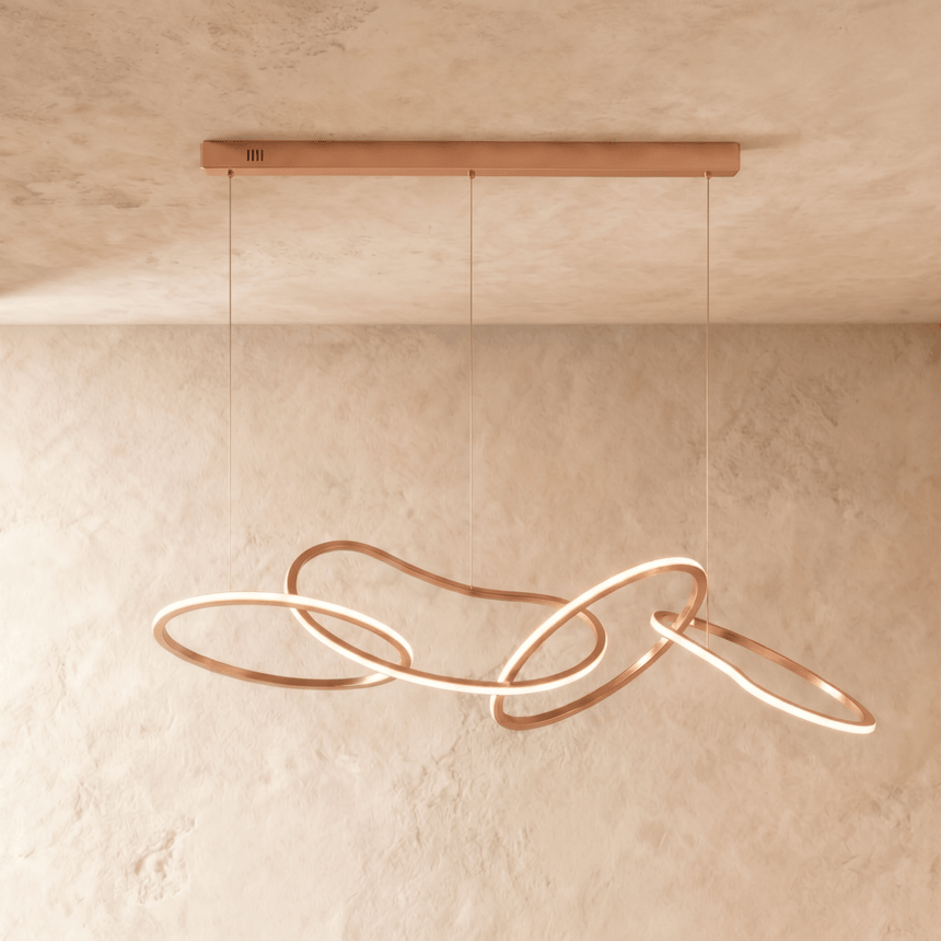 The rose gold loops spread along the bar, rings crossing at several depths