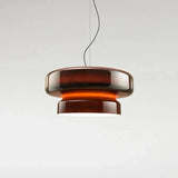 Amber tinted glass shade lit on a plain background