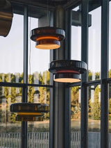 Tinted glass shades hung in a space with glass walls