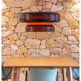 Red tinted glass shade on a plain background
