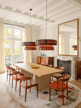 Tinted glass shade above a table beside a window