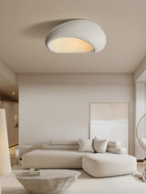 Textured dome ceiling light in a living room with a curved sofa and framed art