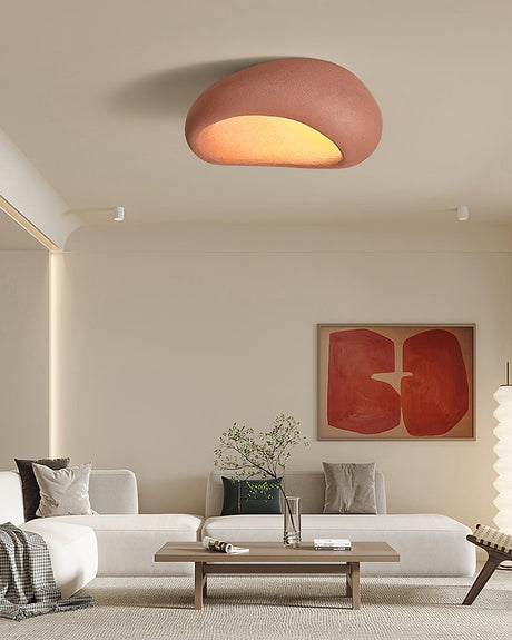 Brick red textured dome ceiling light in a living room with a red artwork