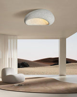 Textured dome ceiling light in an open space with a dune backdrop