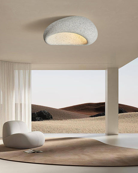 Textured dome ceiling light in an open space with a dune backdrop