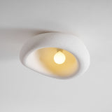 Textured dome ceiling light lit with the bulb visible inside the opening