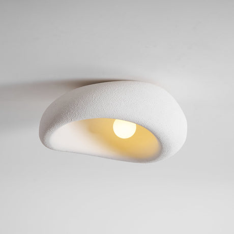 Textured dome ceiling light lit, seen from the side against a pale wall