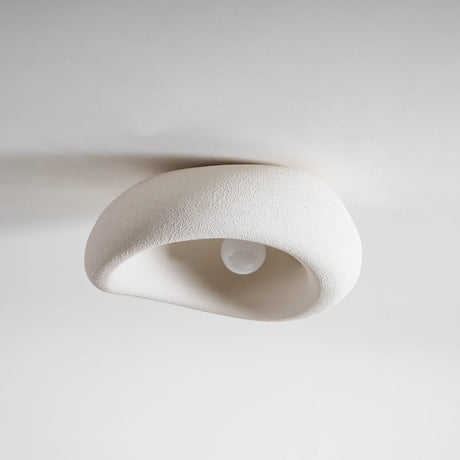 Textured dome ceiling light seen from below showing the socket inside