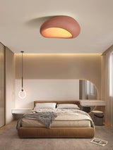 Brick red dome ceiling light in a bedroom with a wood bed and warm lighting