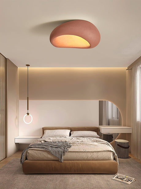 Brick red dome ceiling light in a bedroom with a wood bed and warm lighting