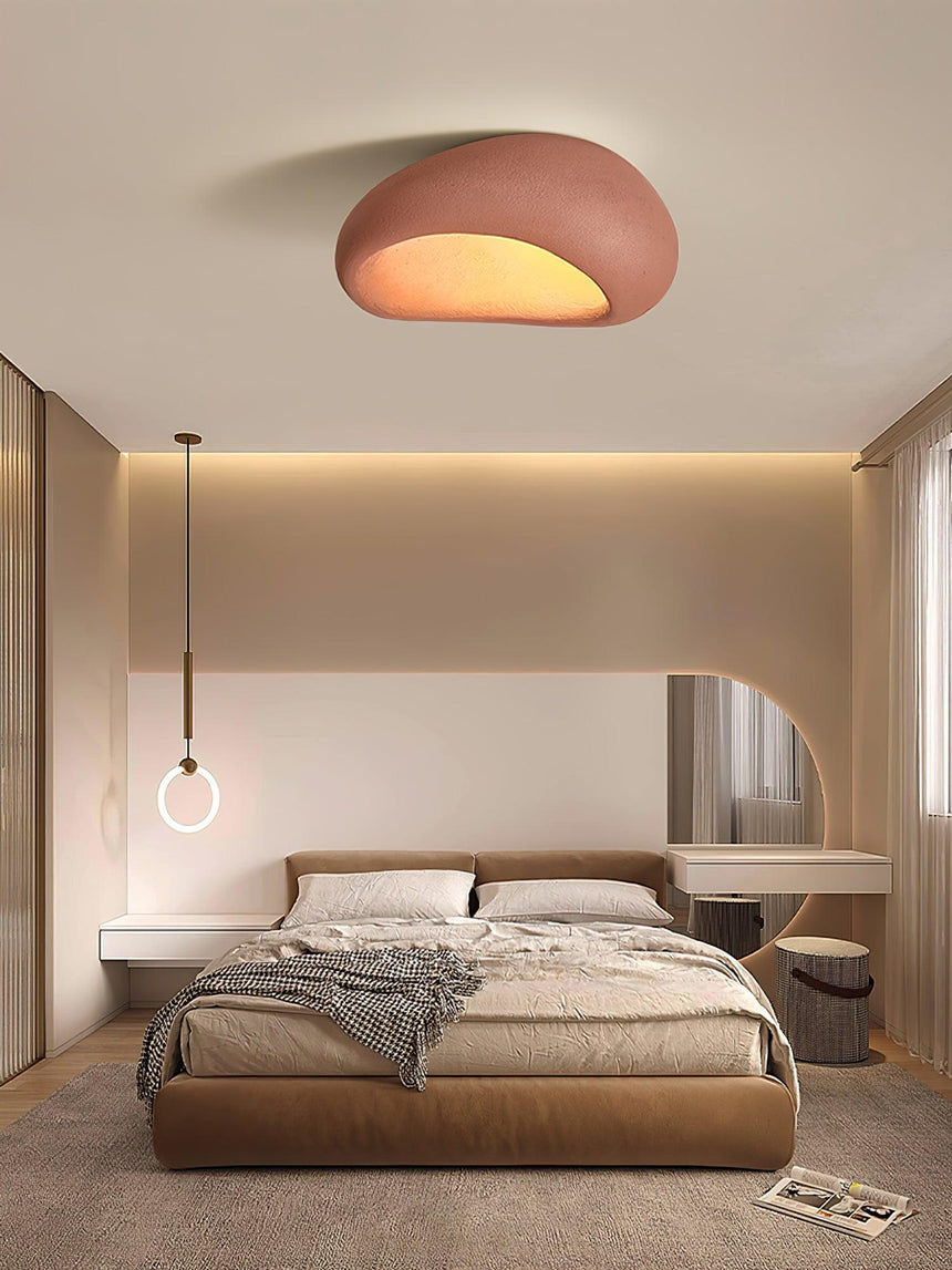 Brick red dome ceiling light in a bedroom with a wood bed and warm lighting