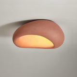 Brick red dome ceiling light lit close up, the opening glowing warm