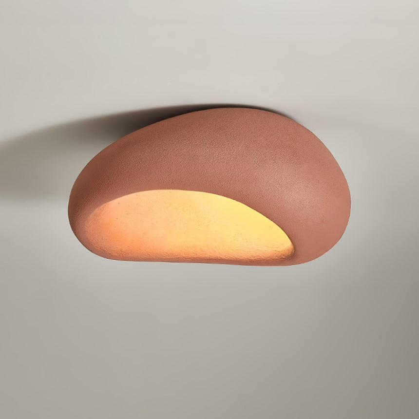 Brick red dome ceiling light lit close up, the opening glowing warm