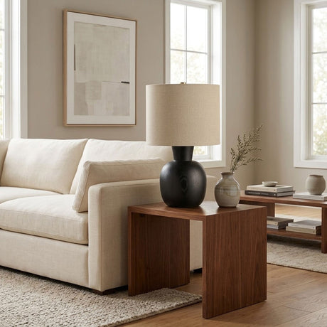 Sphere base lamp lit on a side table beside a cream sofa