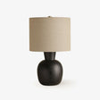 Table lamp with a black wood sphere base and a small beige linen drum
