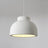 Rounded ceiling light with a textured white shade against a pale wall