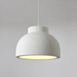 Rounded ceiling light with a textured white shade against a pale wall