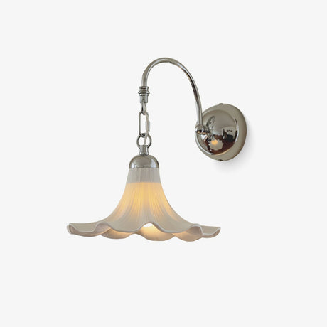 Chrome gooseneck wall sconce with a white ruffled ceramic shade shaped like a flower