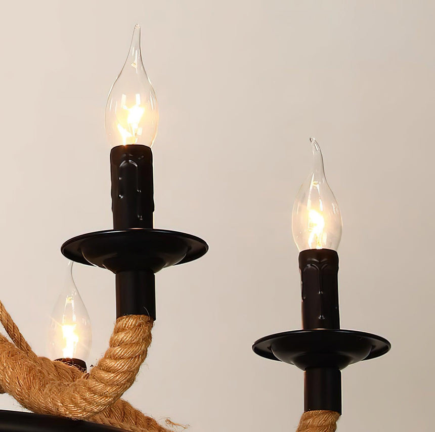 Two black candle cups with flame tip lamps burning above the rope