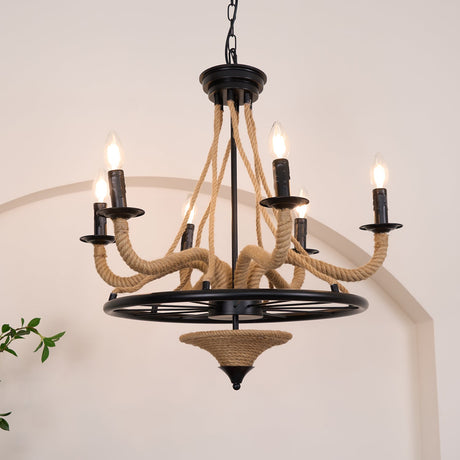 Chandelier lit above a wood console with framed pictures behind it