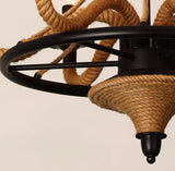 The spoked iron wheel and the rope wrapped cone beneath it