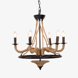Rustic chandelier with rope wrapped arms rising from a black iron wheel