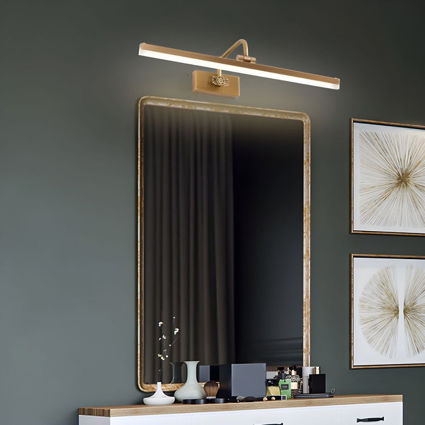 Gold antler bar lit above a framed mirror on a dressing table with framed prints