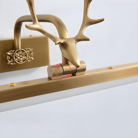 Close view of the cast gold antler head where it seats on the lit bar