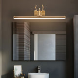 Gold antler bar lit above a wide mirror over a stone basin and a towel rail