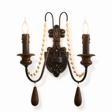 The beaded design with two candle arms and two strands of pale wood beads