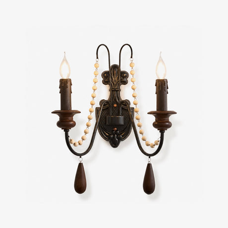 Rustic wall lamp, an iron scroll hung with wood beads carrying two candle arms