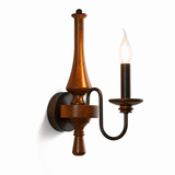 The turned wood candlestick with one iron candle arm off its side