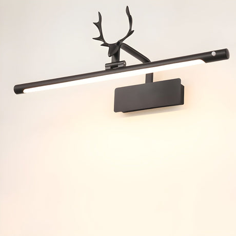 The black version lit on a pale wall, the antlers dark against the bright tube