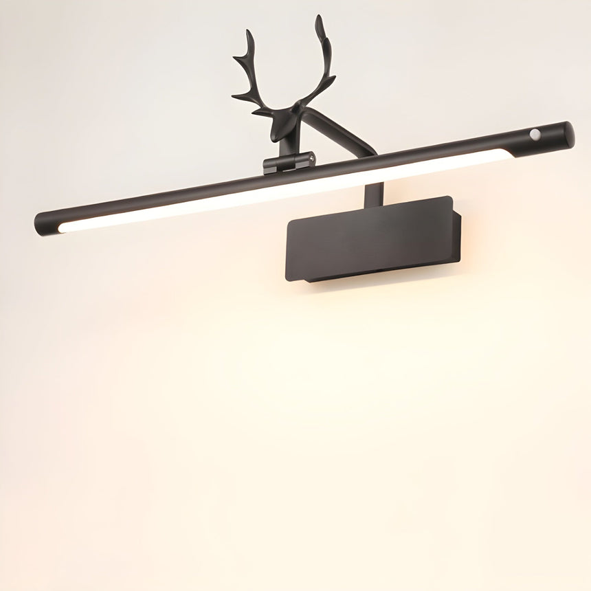 The black version lit on a pale wall, the antlers dark against the bright tube