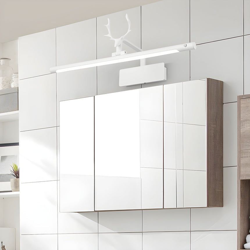 White bar with a white stag head lit above a tiled mirror cabinet in a bathroom
