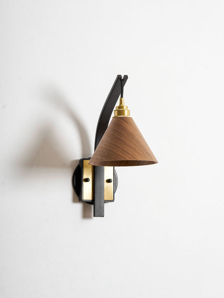 Curved arm sconce seen at an angle showing how far it reaches out