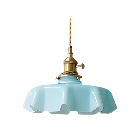 Blue scalloped glass shade with a brass top on a plain white background